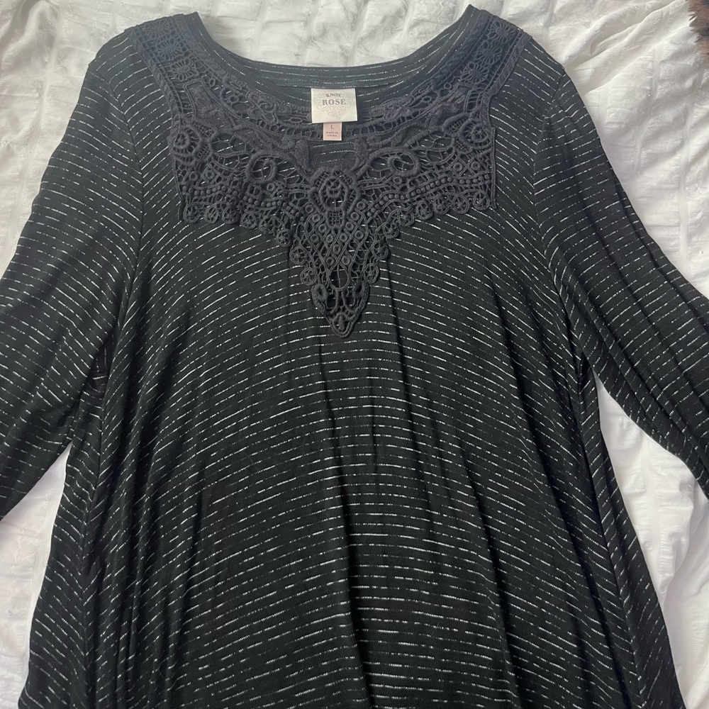 black flowy long sleeve tee with a pattern in the front